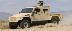 Digital photograph of a Navistar Defense MXT-MVA with CG weapon retouched into desert